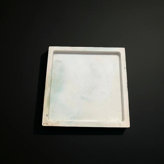 Handgemachtes, viereckiges Kerzentablett aus Marmor-Optik auf dunklem Hintergrund